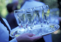 person carrying a tray of champagne