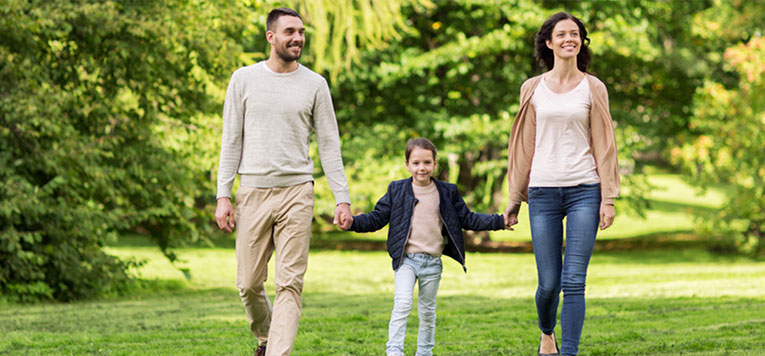 family holding hands and walking