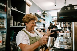 Person using a coffee machine in a cafe