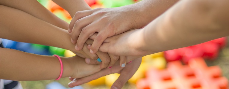 Family placing hands on top of each other