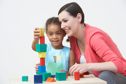 parent and child playing with building blocks