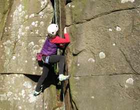 person rock climbing
