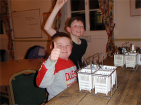 2 children sitting at a dining table