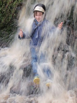 young person in a waterfall