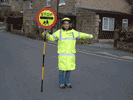 school crossing patrol person holding sign extended out