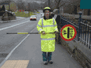 crossing patrol person holding sign sideways