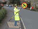  school crossing patrol person holding sign up