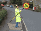 school crossing patrol person holding sign up