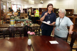 two women chat by a table at YMCA Swadlincote