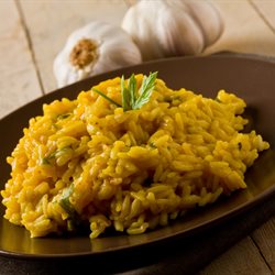 risotto with saffron on wooden table with garlic