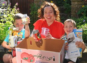 Smiling family recycles in the garden