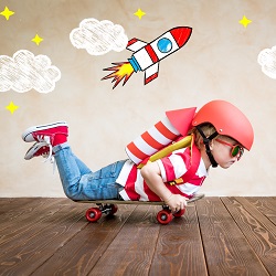 Boy on a skateboard pretending it is a rocket