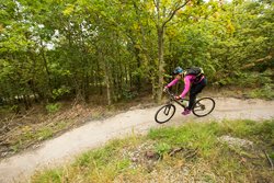 Woman cycling along a trail