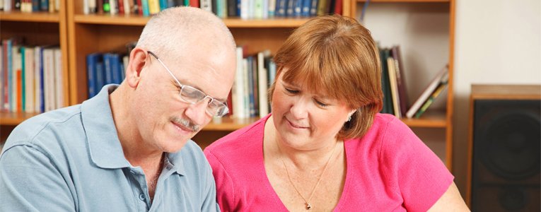 man and woman sat in a library