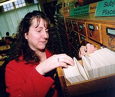 woman looking in a drawer of record cards