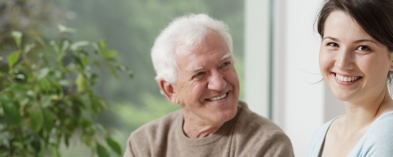 Woman and elderly man smiling