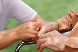 a younger and older person holding hands