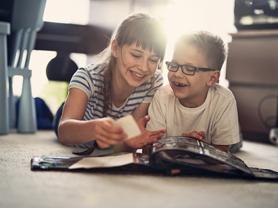 Brother and sister looking at a photo album
