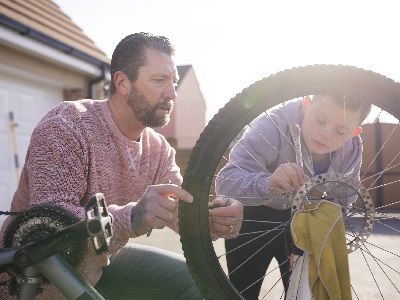 Dad and son fixing a bike