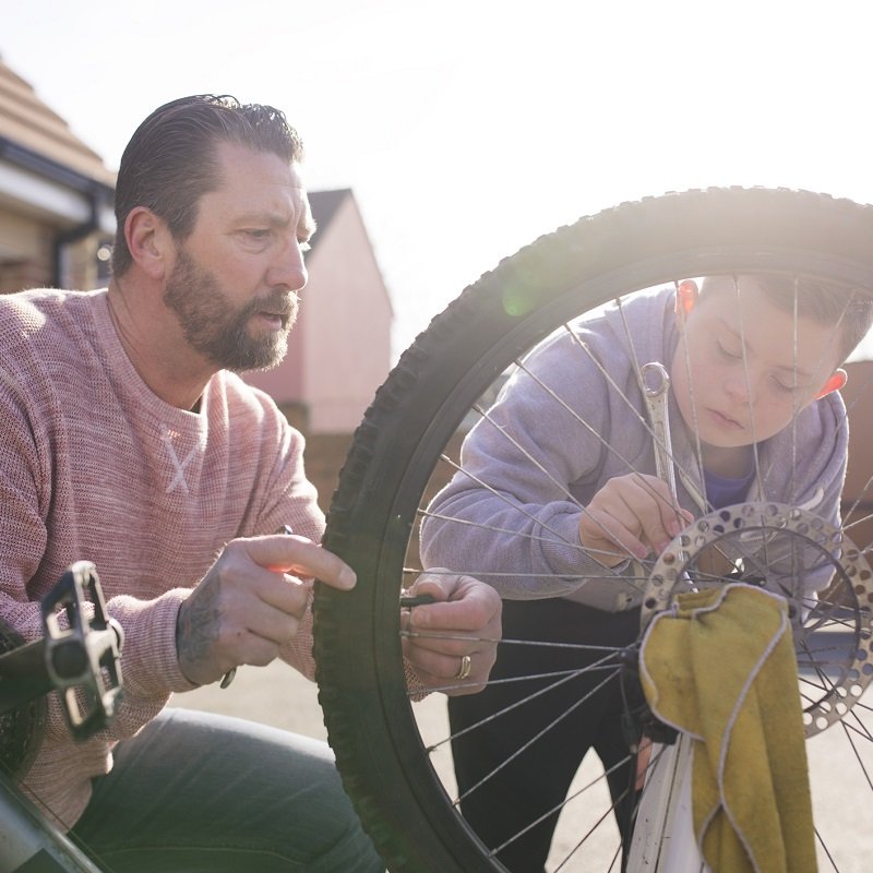 Dad and son fixing a bike