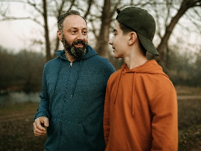 Father and son walking through the woods