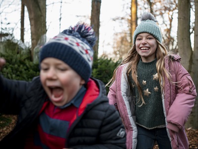 Sister and brother playing in the woods