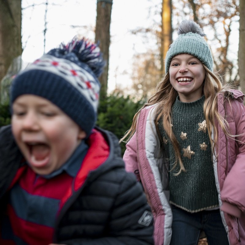 Sister and brother playing in the woods