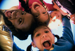 Four children putting their heads together