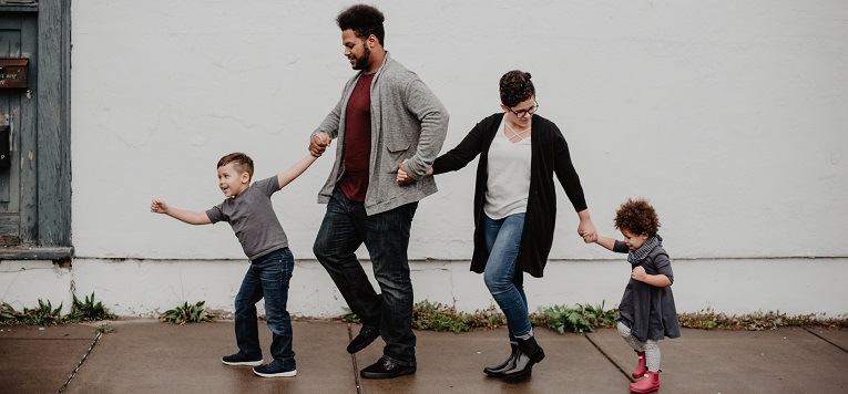 Family holding hands and walking