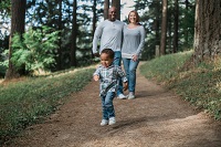 Family walking through a forest