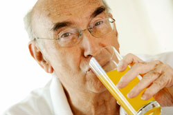Older man drinking orange juice