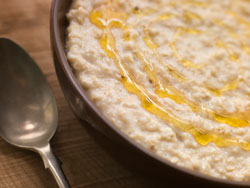 Bowl of porridge and spoon on a table