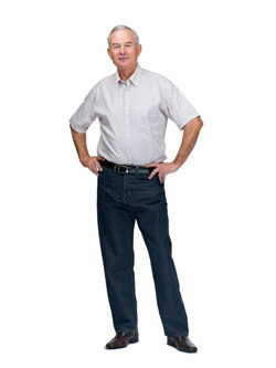 Elderly man stood with hands on his hips