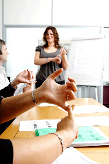 Woman teaching sign language in an office